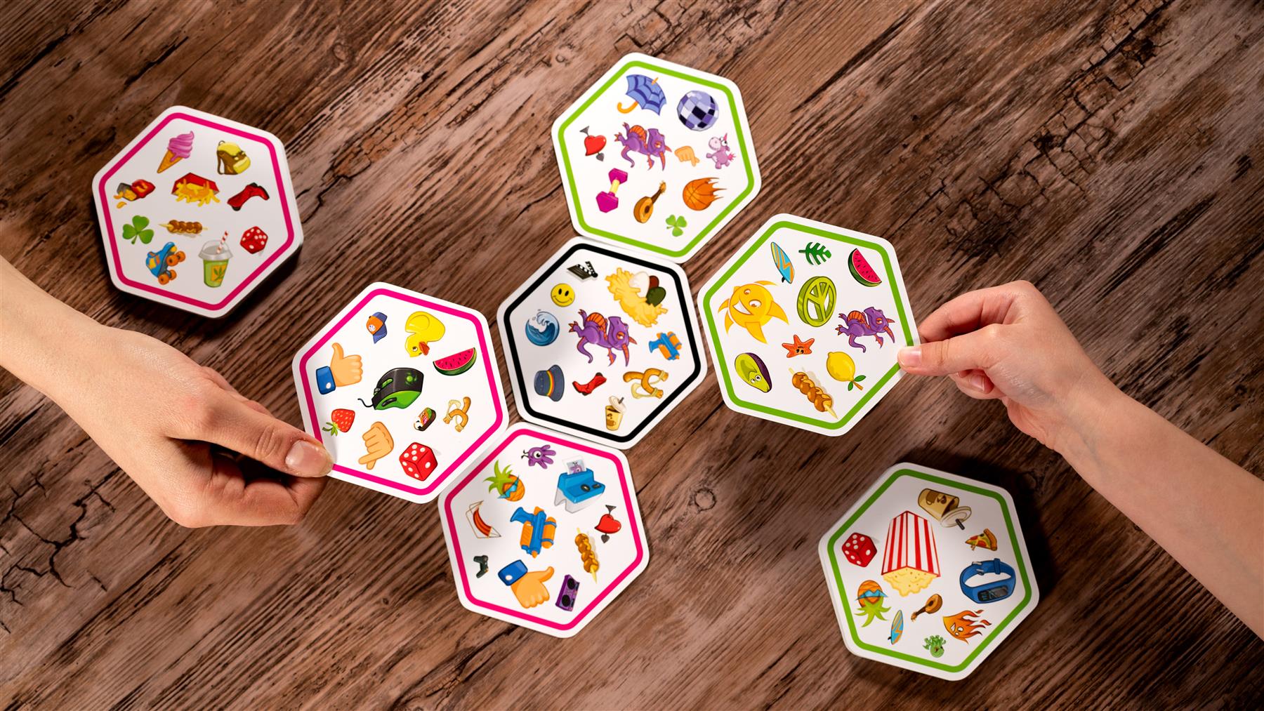 Colorful hexagonal cards with illustrations on a wooden surface